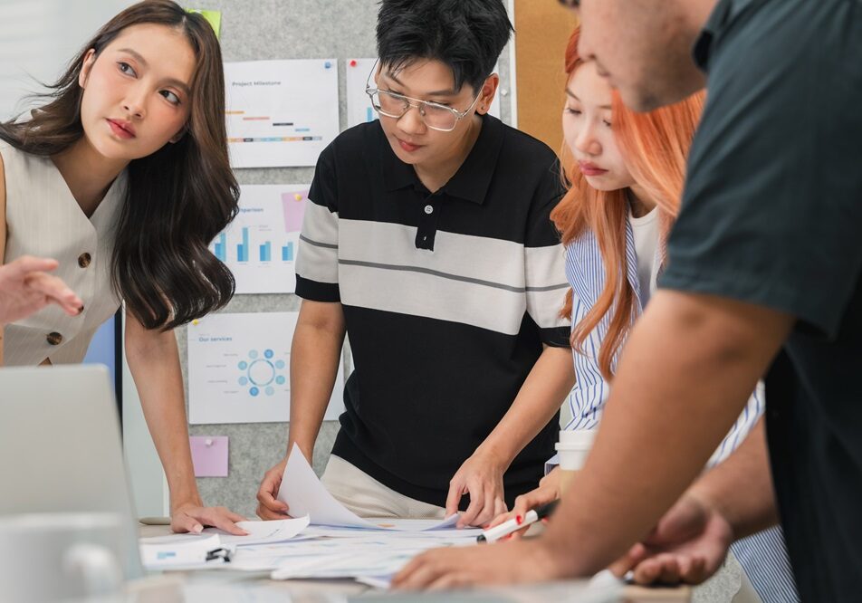 During an agile hackathon, a closeup of hands shows a team using data analytics for strategic insights. This collaboration drives innovation and digital transformation.